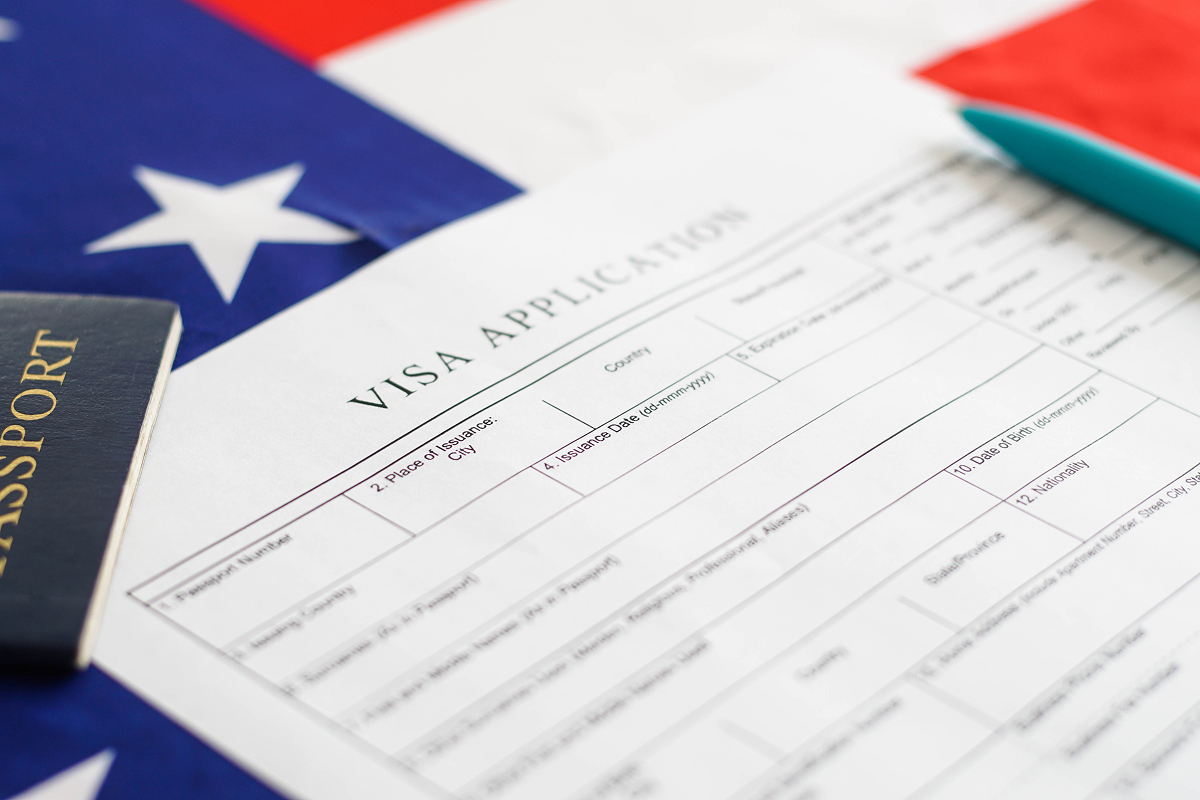 H-1B visa application form with a US flag and passport.
