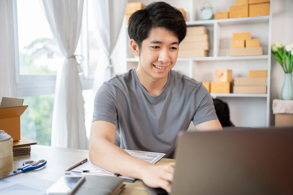 Person using a laptop to apply for h-1b visa.