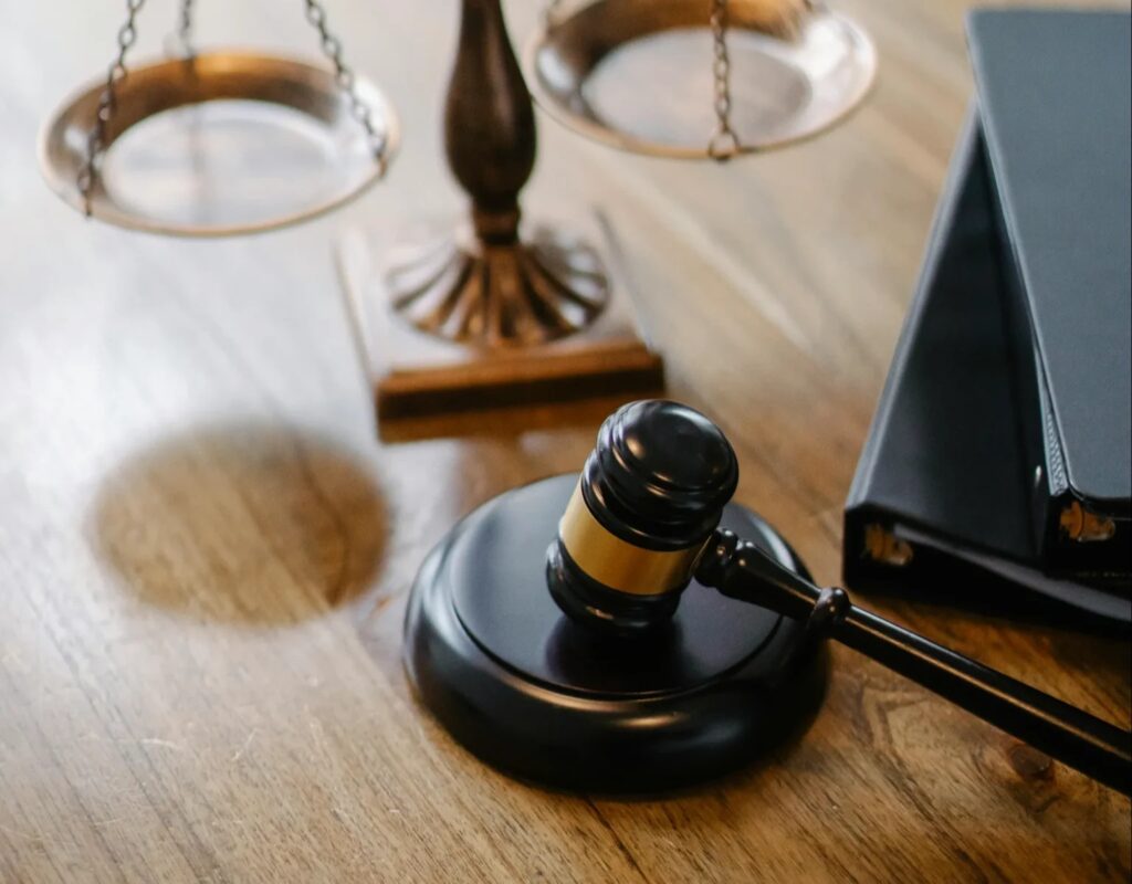 Gavel with a scale on a desk.