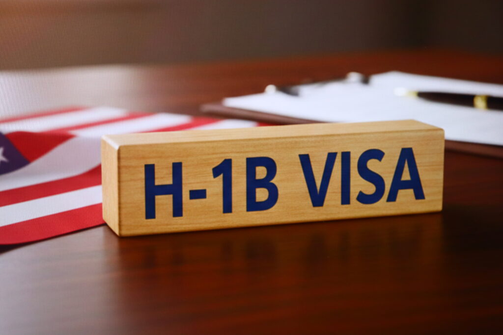 A placard with H-1B visa on a desk.
